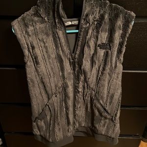 Furry hooded north face vest.
